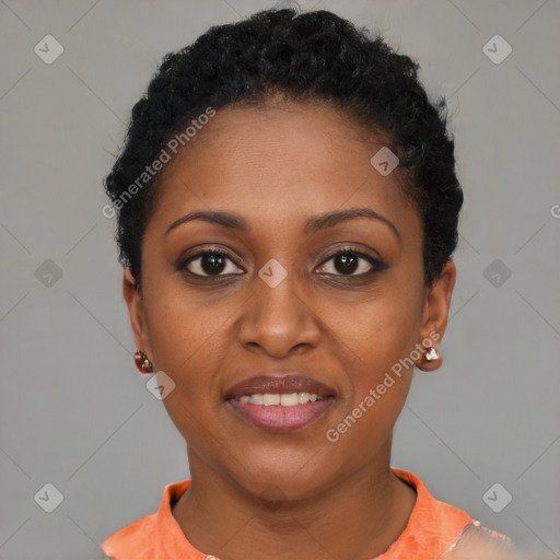 Joyful black young-adult female with short  black hair and brown eyes