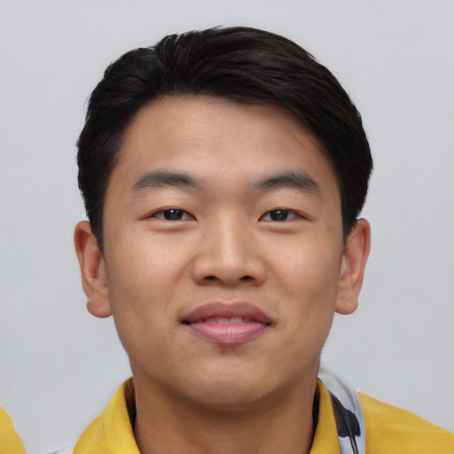 Joyful asian young-adult male with short  black hair and brown eyes
