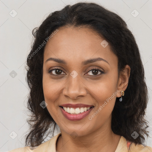 Joyful black young-adult female with long  brown hair and brown eyes