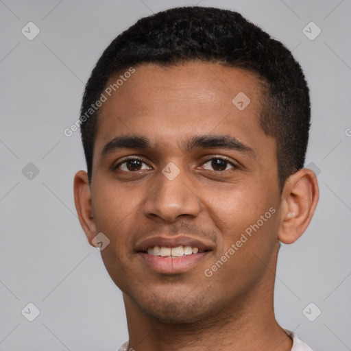 Joyful black young-adult male with short  brown hair and brown eyes