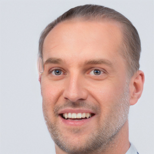 Joyful white adult male with short  brown hair and brown eyes