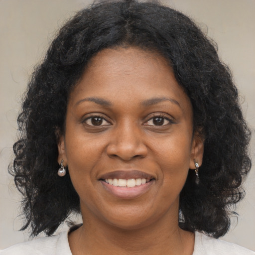 Joyful black young-adult female with medium  brown hair and brown eyes
