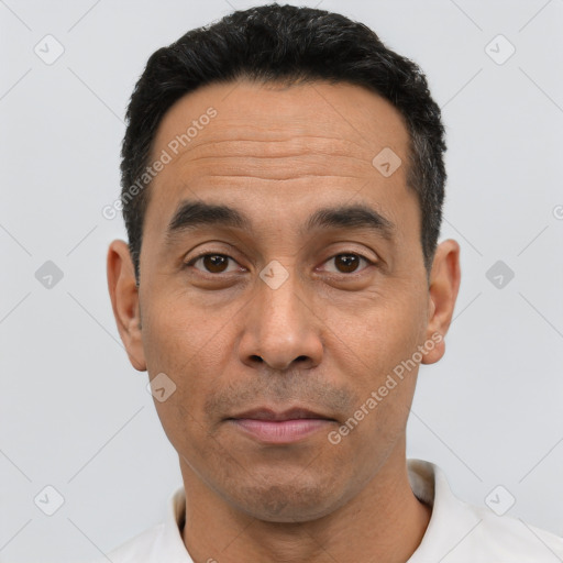 Joyful white adult male with short  black hair and brown eyes