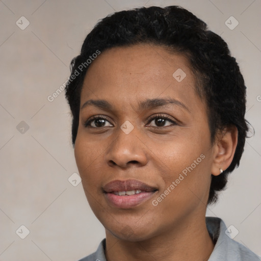 Joyful black young-adult female with short  black hair and brown eyes