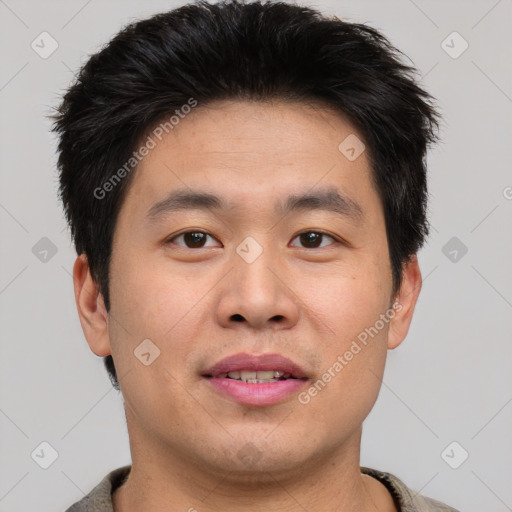 Joyful asian young-adult male with short  brown hair and brown eyes