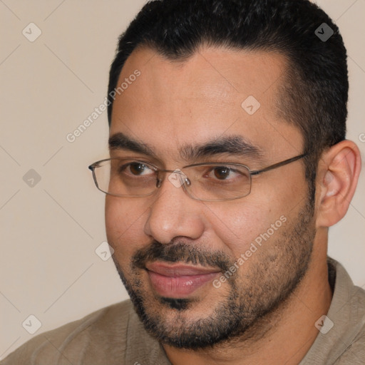 Joyful white adult male with short  black hair and brown eyes