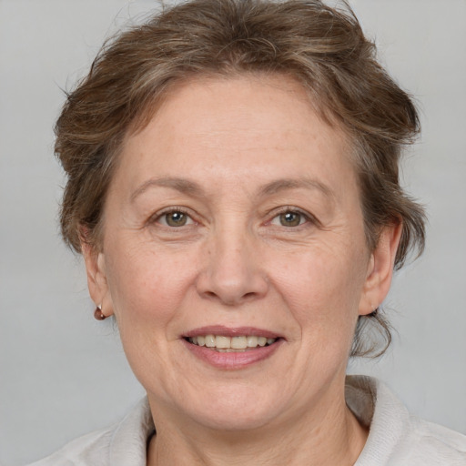 Joyful white middle-aged female with medium  brown hair and brown eyes