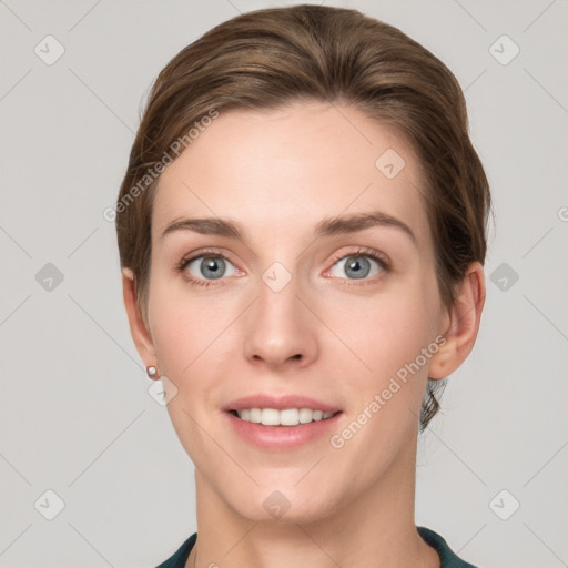 Joyful white young-adult female with short  brown hair and grey eyes