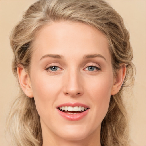 Joyful white young-adult female with long  brown hair and blue eyes