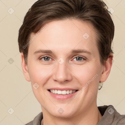 Joyful white young-adult female with short  brown hair and grey eyes