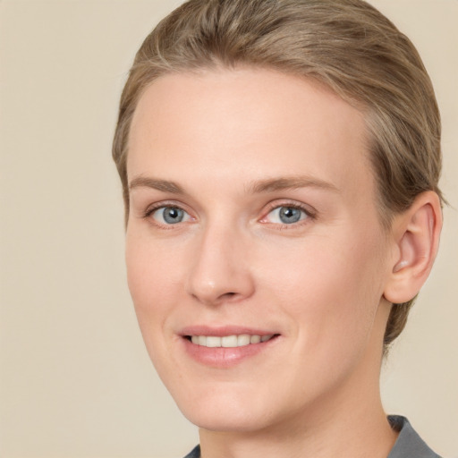 Joyful white young-adult female with short  brown hair and grey eyes