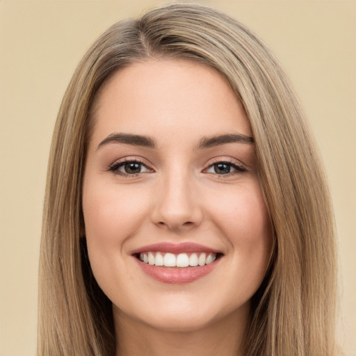 Joyful white young-adult female with long  brown hair and brown eyes