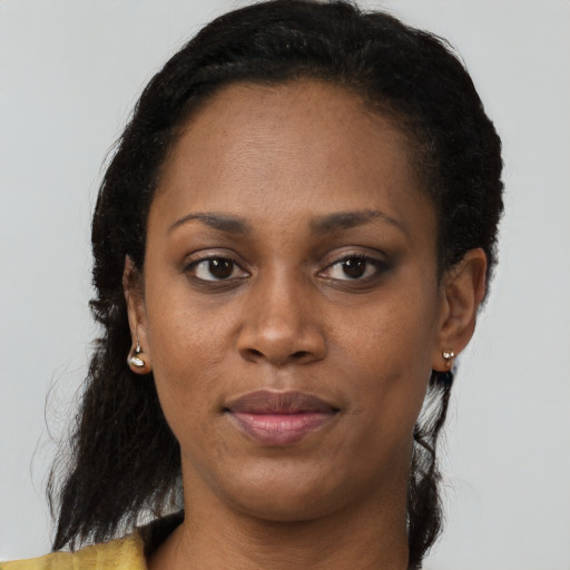 Joyful black young-adult female with short  brown hair and brown eyes