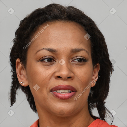 Joyful black adult female with medium  brown hair and brown eyes