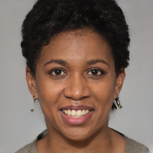 Joyful black young-adult female with short  brown hair and brown eyes