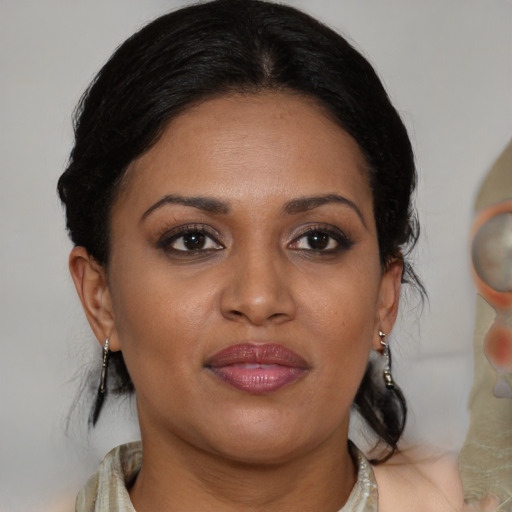 Joyful black adult female with medium  brown hair and brown eyes