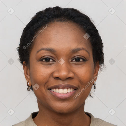 Joyful black young-adult female with short  black hair and brown eyes