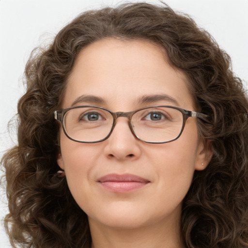 Joyful white adult female with long  brown hair and brown eyes