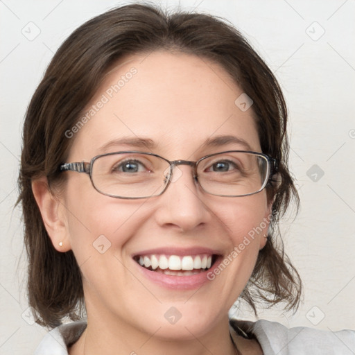 Joyful white adult female with medium  brown hair and blue eyes