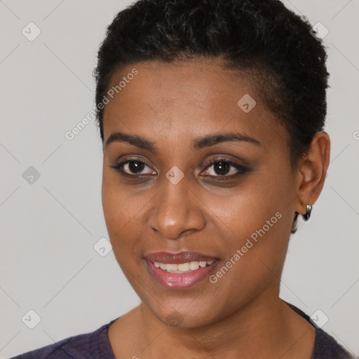 Joyful black young-adult female with short  black hair and brown eyes