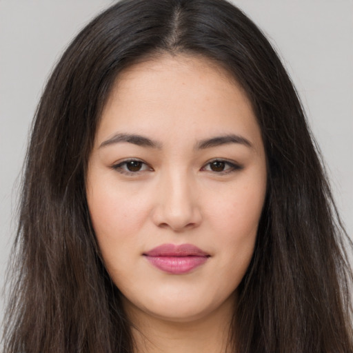 Joyful asian young-adult female with long  brown hair and brown eyes