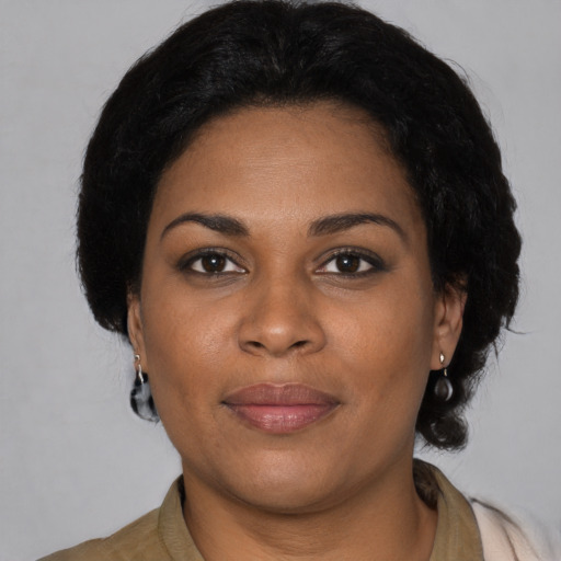 Joyful black young-adult female with medium  brown hair and brown eyes