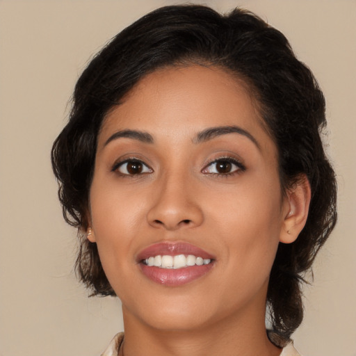 Joyful latino young-adult female with medium  brown hair and brown eyes