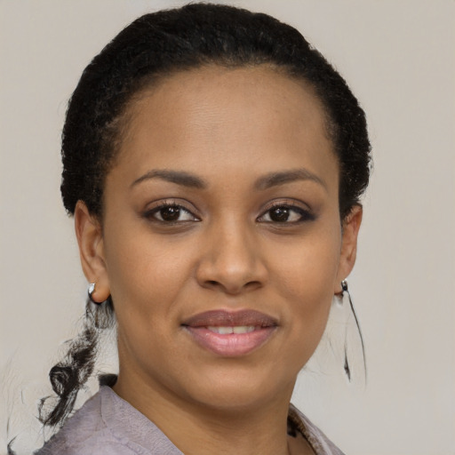 Joyful black young-adult female with short  brown hair and brown eyes