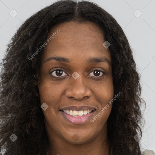 Joyful black young-adult female with long  brown hair and brown eyes