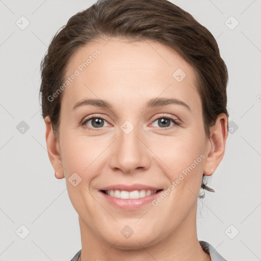 Joyful white young-adult female with short  brown hair and grey eyes