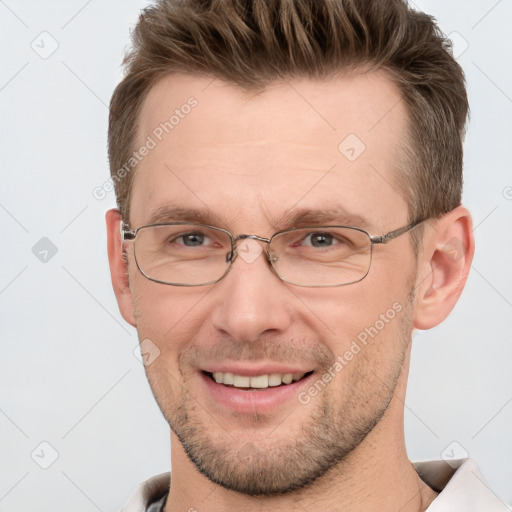 Joyful white adult male with short  brown hair and grey eyes