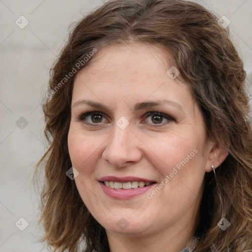 Joyful white adult female with medium  brown hair and green eyes