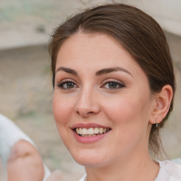 Joyful white young-adult female with medium  brown hair and blue eyes