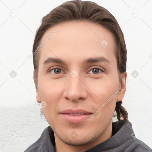 Joyful white young-adult male with short  brown hair and grey eyes