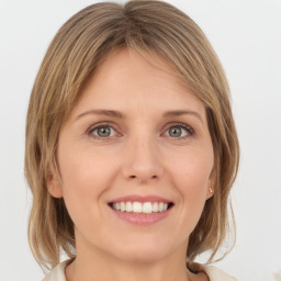 Joyful white young-adult female with medium  brown hair and green eyes