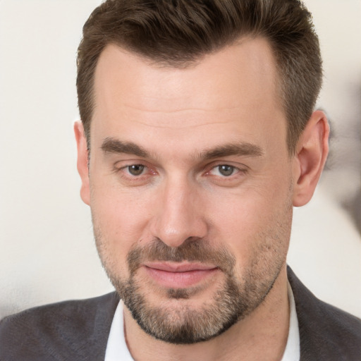 Joyful white adult male with short  brown hair and brown eyes