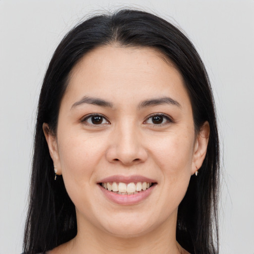 Joyful asian young-adult female with long  brown hair and brown eyes