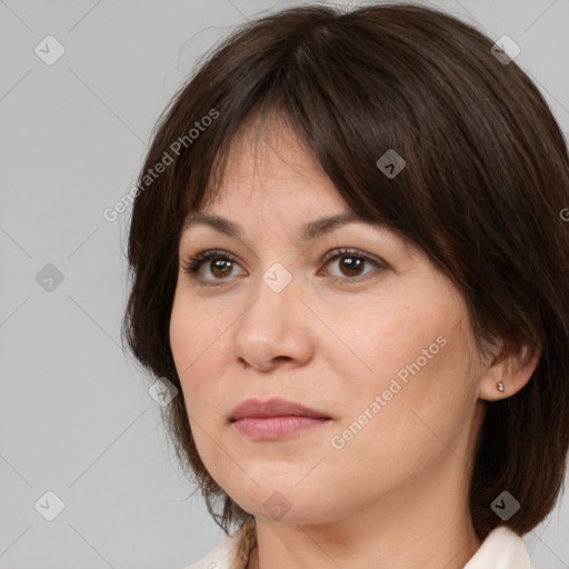 Joyful white adult female with medium  brown hair and brown eyes