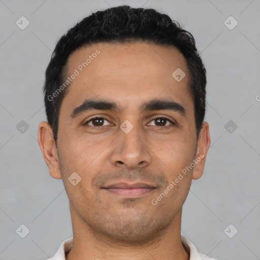 Joyful latino young-adult male with short  black hair and brown eyes