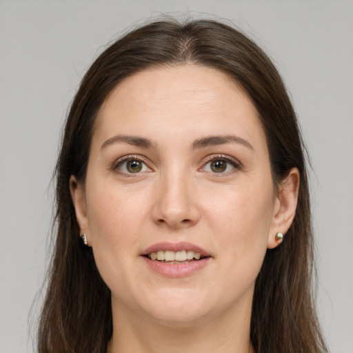 Joyful white young-adult female with long  brown hair and brown eyes