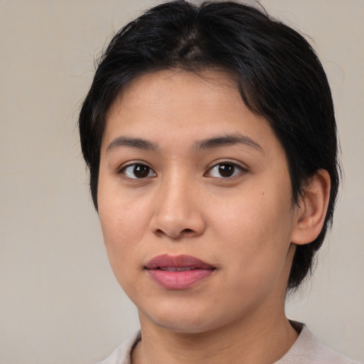 Joyful asian young-adult female with medium  brown hair and brown eyes