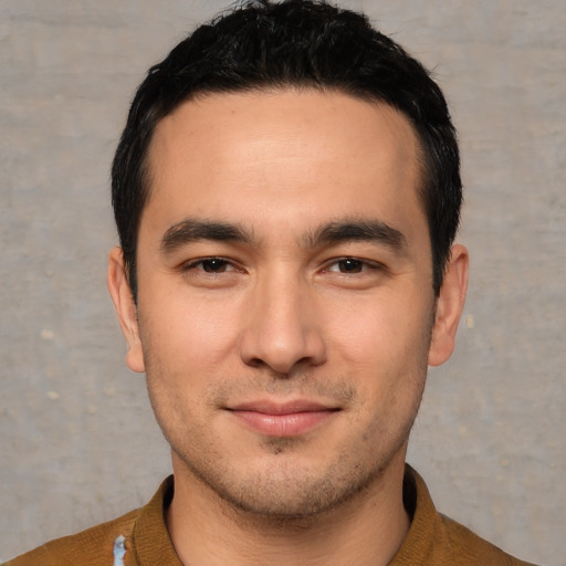 Joyful white young-adult male with short  black hair and brown eyes
