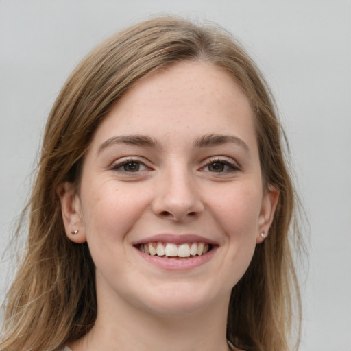 Joyful white young-adult female with long  brown hair and grey eyes