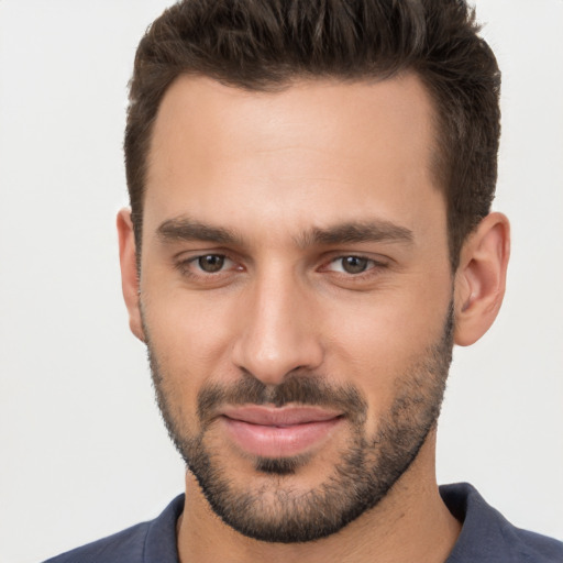 Joyful white young-adult male with short  brown hair and brown eyes