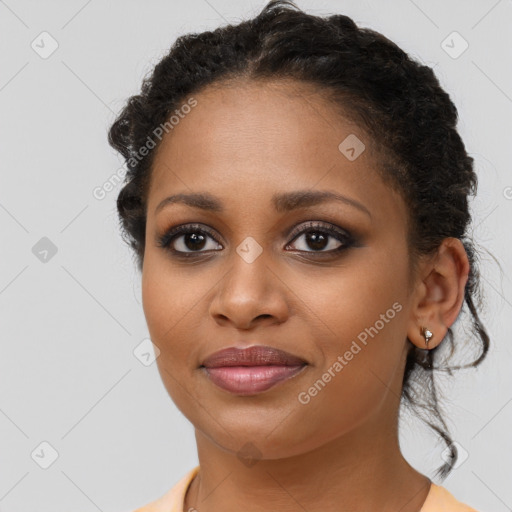 Joyful black young-adult female with medium  brown hair and brown eyes