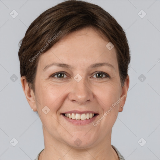 Joyful white adult female with short  brown hair and grey eyes