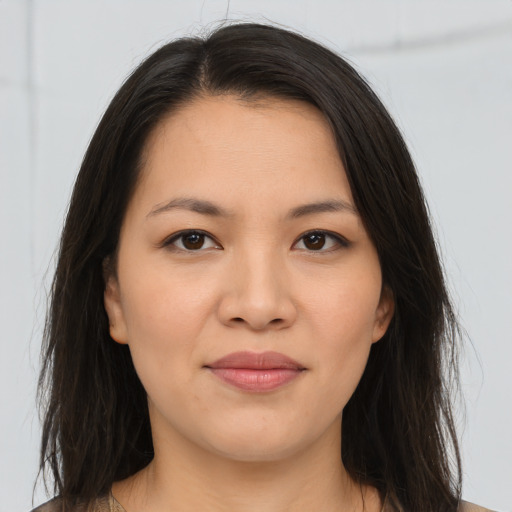Joyful asian young-adult female with long  brown hair and brown eyes