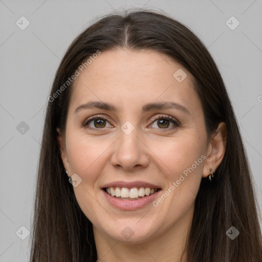 Joyful white young-adult female with long  brown hair and brown eyes