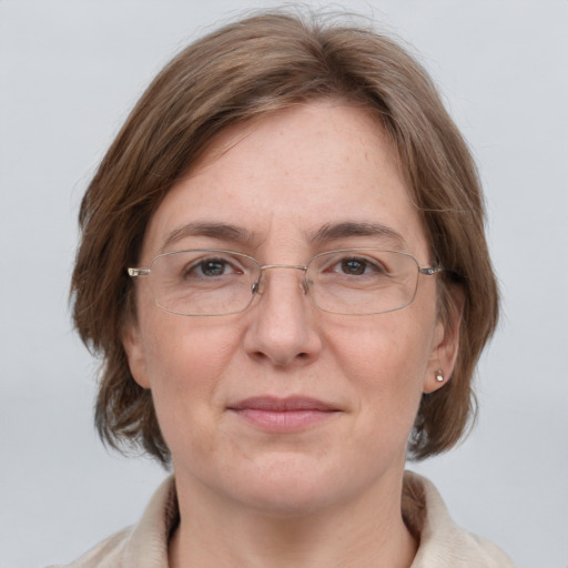 Joyful white adult female with medium  brown hair and grey eyes