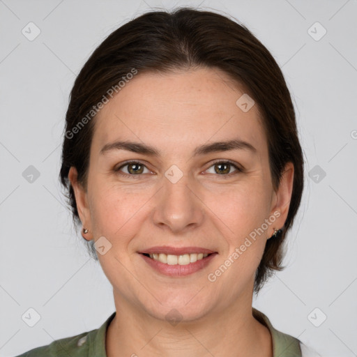 Joyful white young-adult female with medium  brown hair and grey eyes